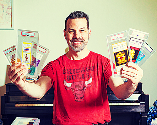 Image of a man holding up encased tickets