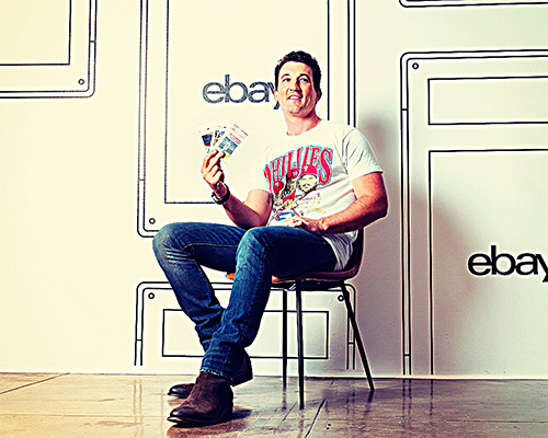 Image of Miles Teller holding sports cards